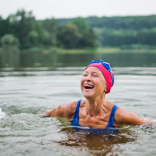 photo of woman smiling while swimming