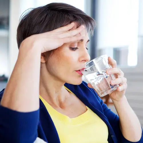 photo of mature woman drinking glass of water