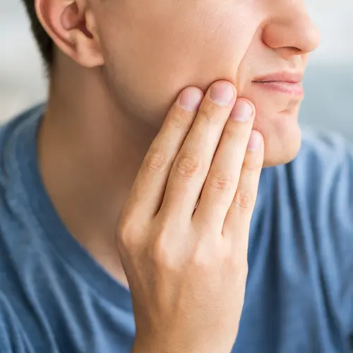 photo of man experiencing dental pain