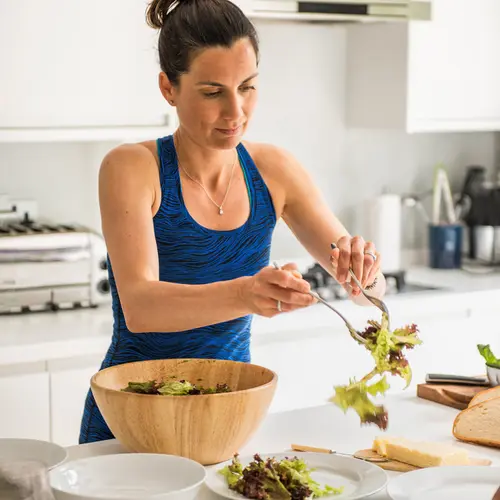 photo of woman making healthy salad