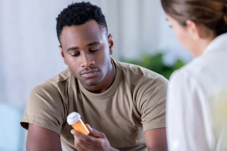 photo of doctor talking to man about medication