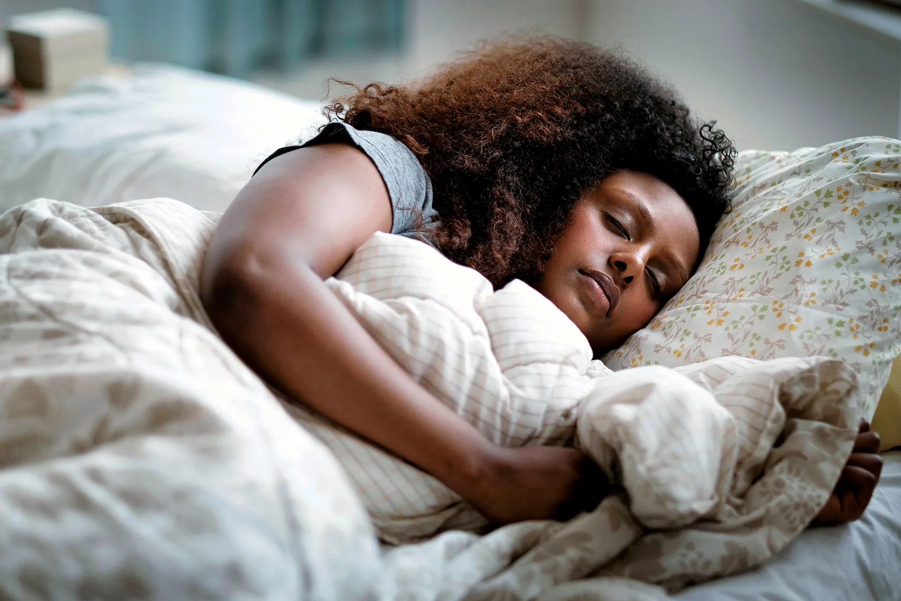 photo of African-American woman sleeping in bed.