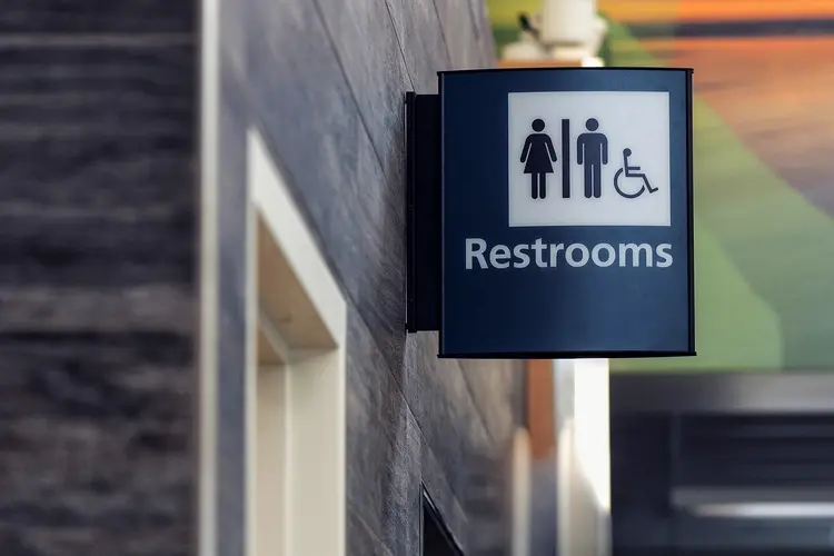 photo of Public restroom sign in airport building