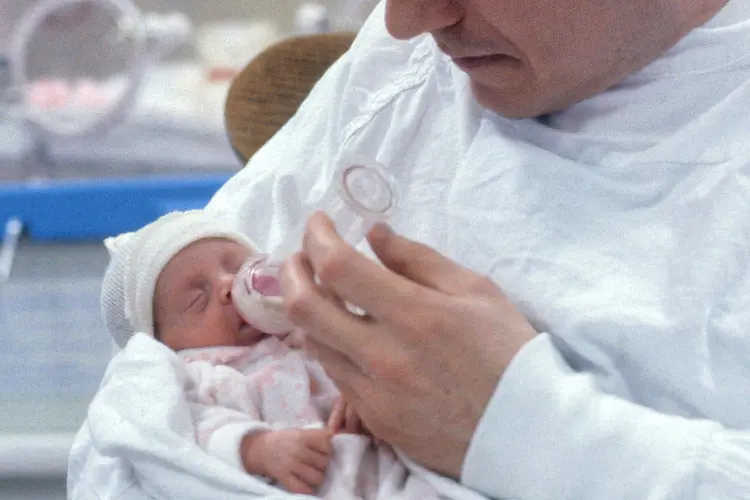 photo of Father feeds his premature baby