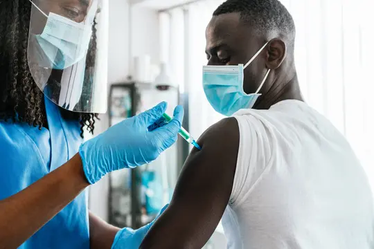 photo of man getting vaccinated