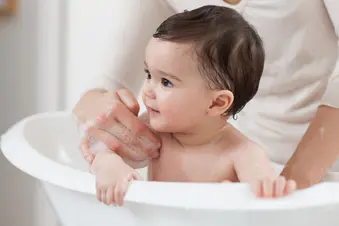 photo of mom bathing baby
