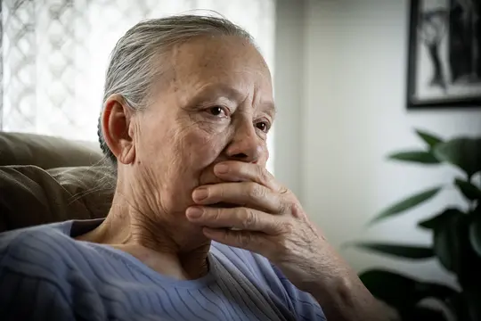 photo of anxious senior woman alone at home