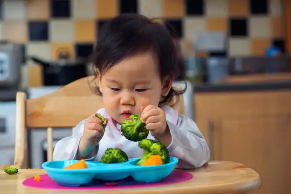 photo of baby eating veggies