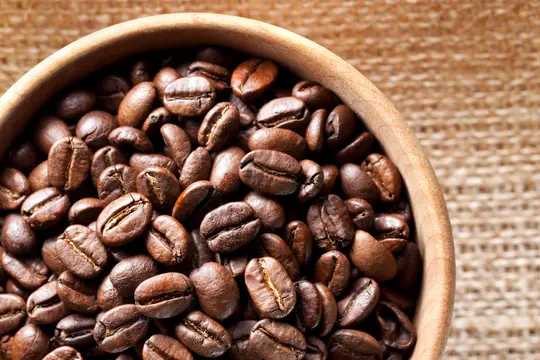 photo of coffee beans in wooden bowl