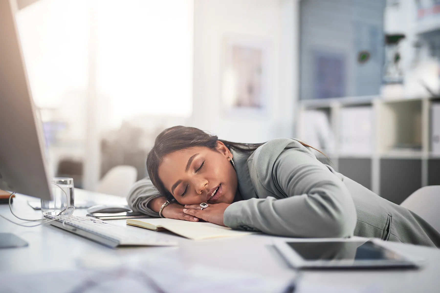 photo of businesswoman sleeping on work desk