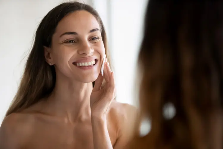 photo of woman cleaning face