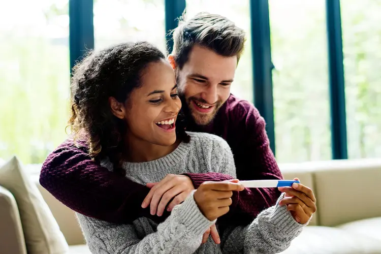 photo of couple holding pregnancy test