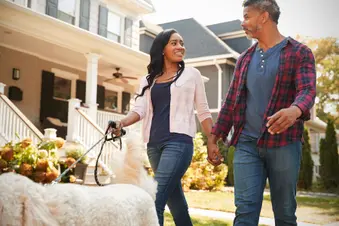 couple walking dog