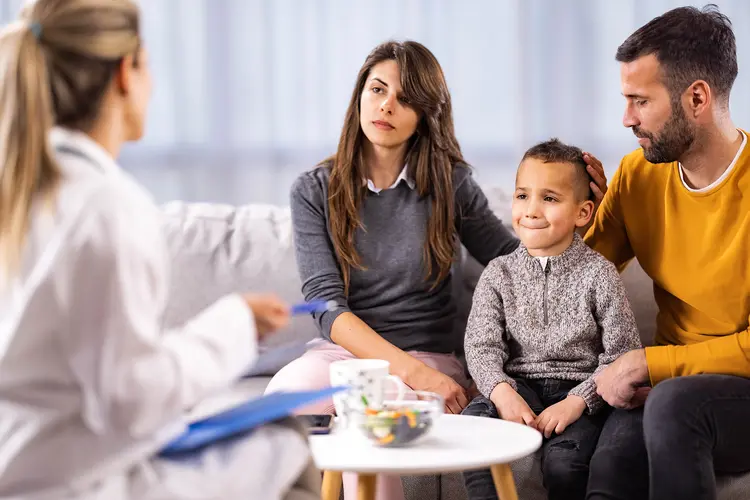 photo of doctor talking with boy's parents
