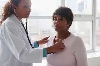 photo of doctor listening to patient's heart