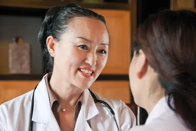 photo of doctor talking with patient
