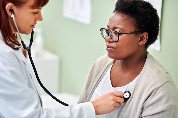 photo of doctor examining patient with stethoscope