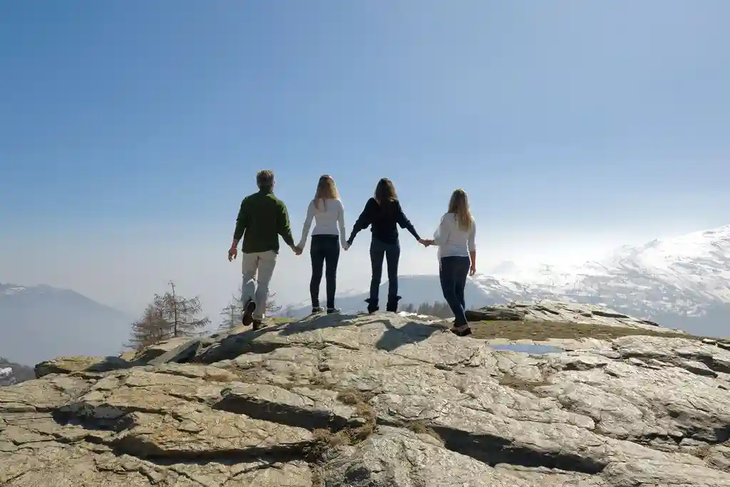 photo of four friends admiring mountain view