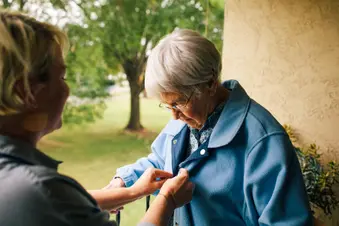 photo of granddaughter dressing grandmother