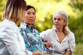 photo of three women chatting in park