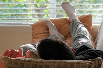 photo of person with feet up on couch