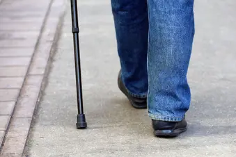 photo of man walking with cane