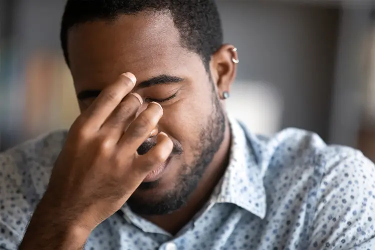 photo of man experiencing eye strain