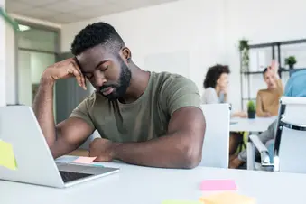 photo of man falling asleep in office