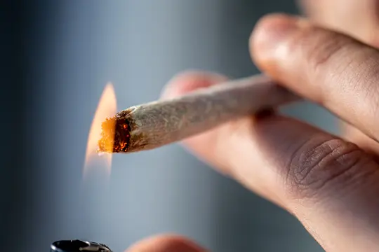 photo of  man lighting joint close up