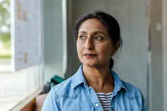photo of mature woman seated by window