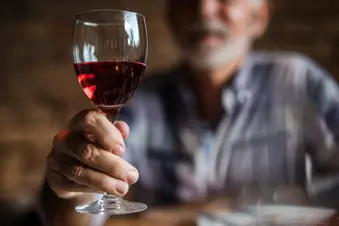 photo of senior man drinking red wine