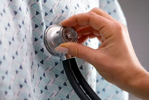 photo of stethoscope on male patient's chest