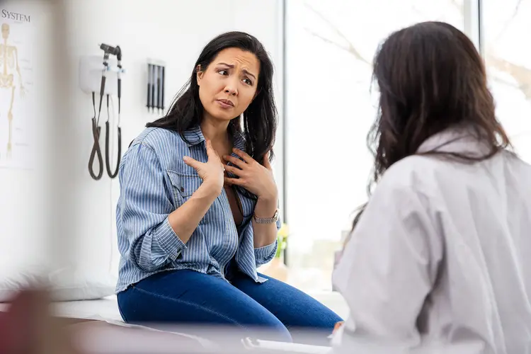 Photo of unhappy patient talking with doctor