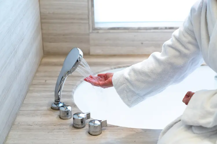photo of woman filling bath
