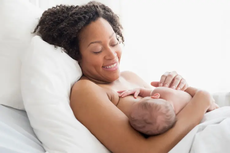 photo of woman breastfeeding newborn