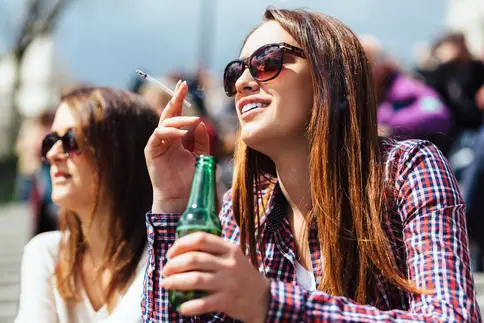 photo of woman drinking beer and smoking