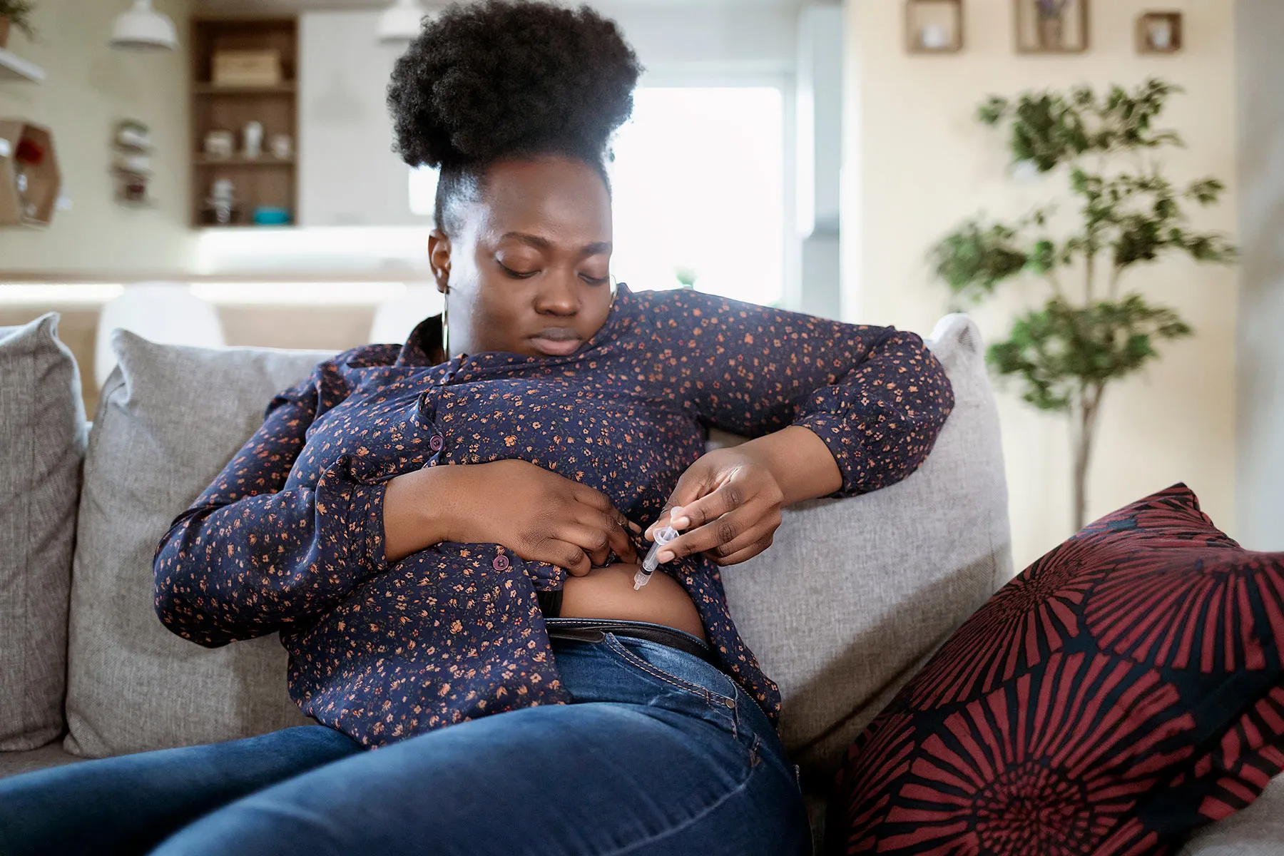 photo of woman giving herself injection