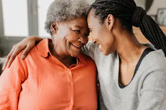 photo of adult woman hugging mother