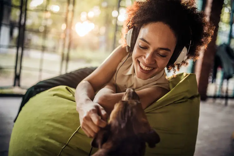 photo of woman playing with dog