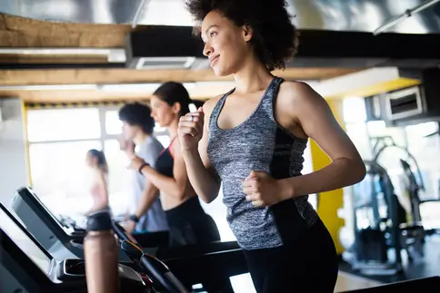 photo of woman running on treadmill