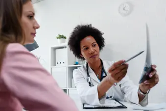 photo of female doctor looking at test results