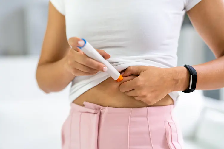 photo of woman using allergy auto injector