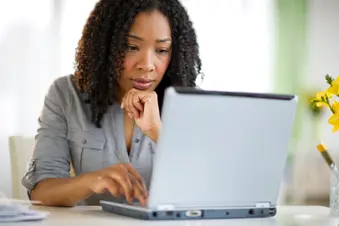 photo of woman using laptop at home