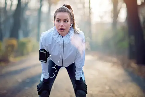 photo of young woman resting after run