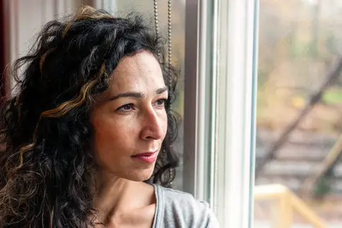 photo of mature woman gazing out window