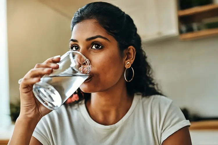 photo of woman drinking water
