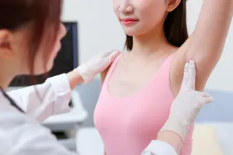photo of doctor checking woman's armpit