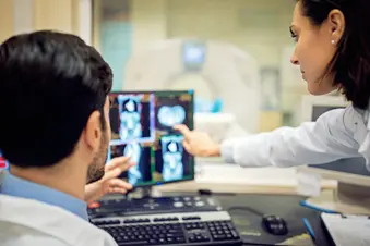 photo of doctors  reviewing abdominal CT scan