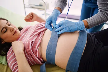 A doctor might use fetal heart rate monitoring to make sure your baby’s heart rate is OK. (Photo Credit: E+/Getty Images)