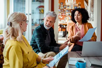 photo of senior couple meeting with broker